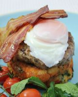 Gluten-free kale potato cakes with sausage, bacon and poached egg