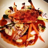 Corn fed breast of chicken with charred baby vegetables, white onion purée and thyme jus